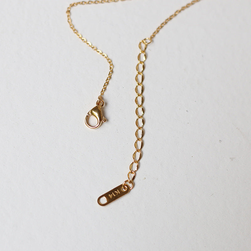 Nelly – Minimalistisches Kreuzhalsband aus Gold